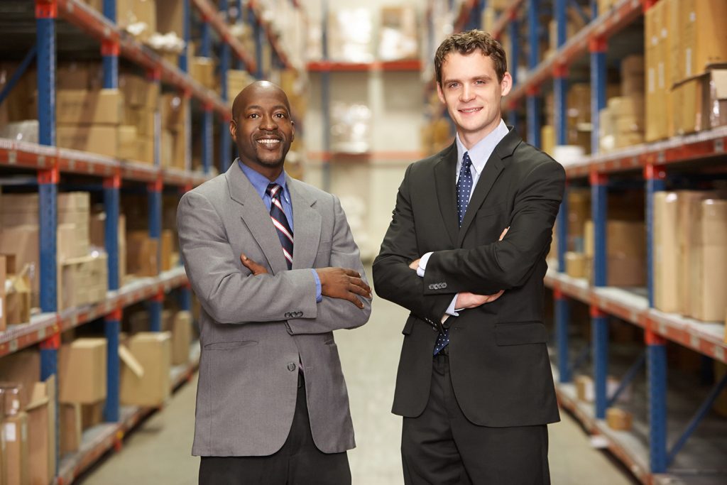 Portrait Of Two Businessmen In Warehouse